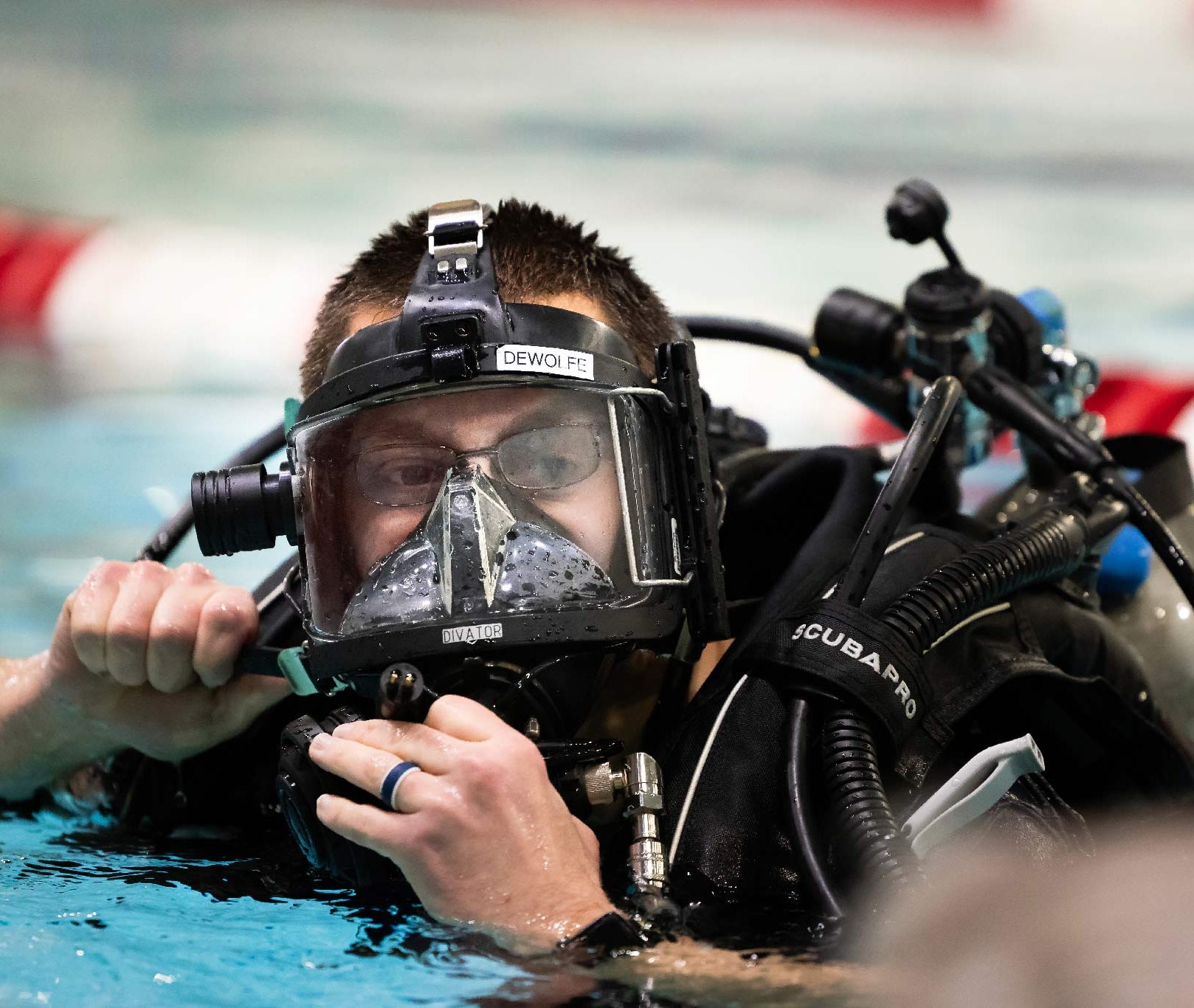 Person wearing scuba diving gear in a pool