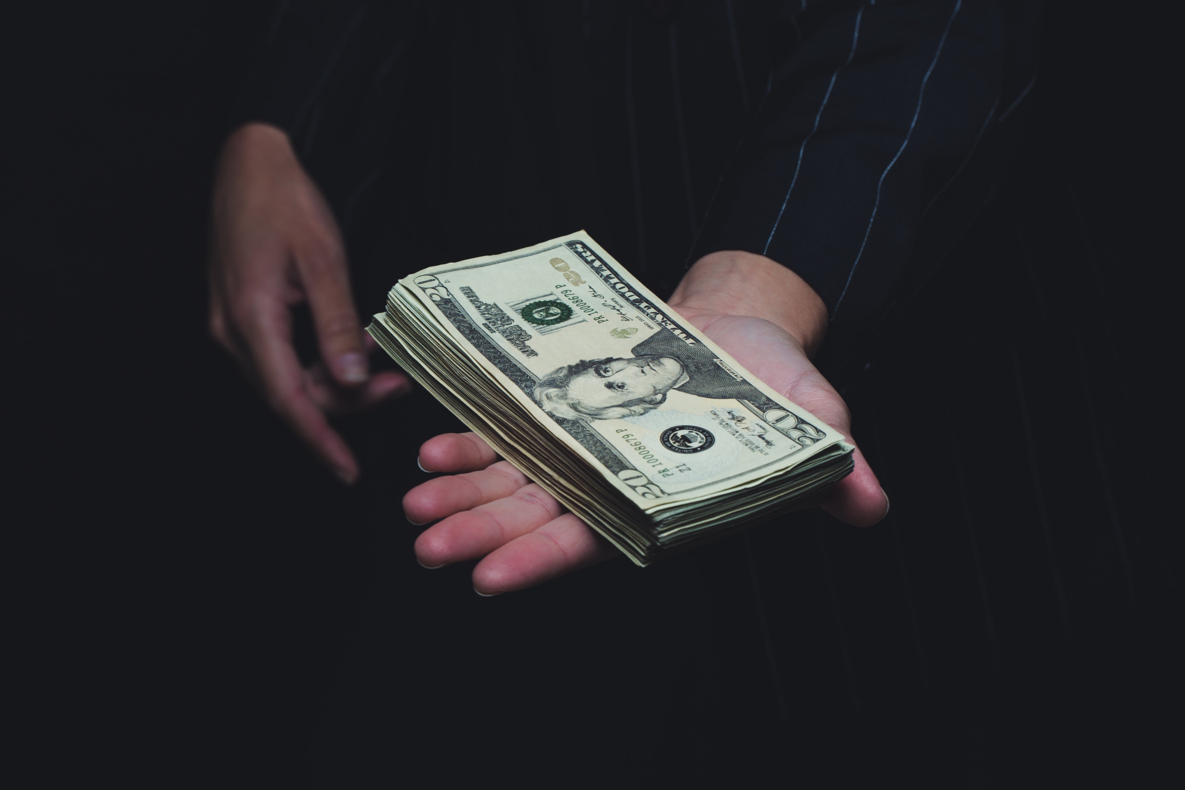 Person holding money in their hands